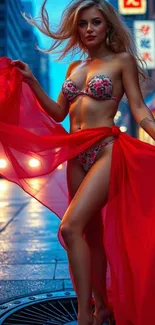 Woman draped in red fabric on city street at night.