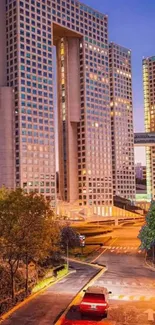 Evening city skyline with illuminated buildings and warm lights.