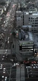 A bustling urban street view at evening with visible traffic and city lights.