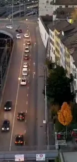 Aerial view of urban street with traffic and colorful buildings during evening hours.