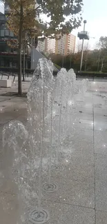 Modern city fountains creating artistic water spray.