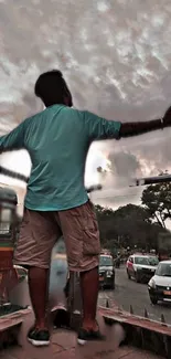 Silhouette of a person embracing city life under a dramatic sky.