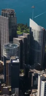 Vibrant city skyline with skyscrapers and a blue waterfront view.