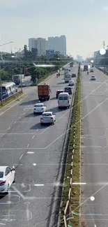 Aerial view of urban highway with moving cars and green surroundings.