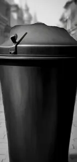 Black trash can on a quiet urban street, minimalistic and aesthetic view.