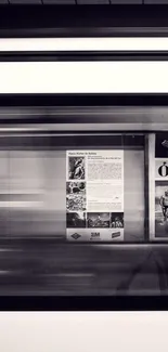 Monochrome subway in motion with blurred city posters on walls.