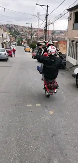 Motorcyclist performing a wheelie on an urban street, showcasing dynamic city life.