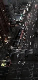 Aerial view of a bustling city street at night with vibrant lights.