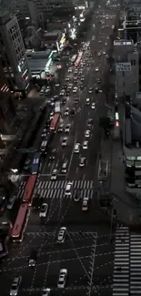 Aerial view of a city street at night with lights and traffic.