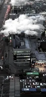 Aerial view of cityscape with cloudy night sky and bustling streets.