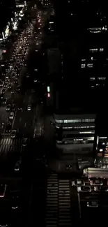 Aerial view of a bustling urban street illuminated at night.