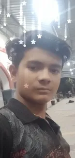 Young man posing at night in city railway station.