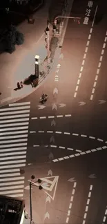 Night street view with warm lighting highlighting empty urban intersection.