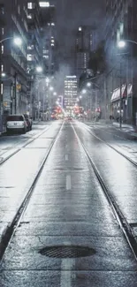 A misty urban street at night with glowing city lights and reflective wet pavement.