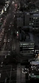 Aerial view of urban night traffic with city lights and buildings.