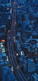 A vibrant cityscape at night with blue lights and tall buildings.