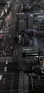 Aerial urban nightscape with busy streets and glowing city lights.