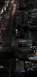 Nighttime view of a bustling city with glowing lights and busy streets.