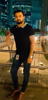 Man standing by railing with urban nightscape background.