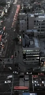 Aerial night view of a bustling city street with vibrant lights and busy traffic.