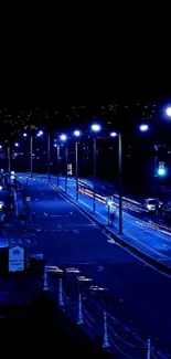 Blue urban nightscape with streetlights and buildings.