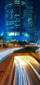 Night cityscape with vibrant light trails and skyscrapers.