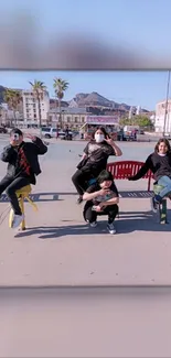 Four friends having fun in an urban outdoor setting with colorful chairs.