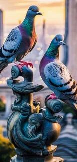 Two pigeons perch on a decorative statue at sunset.
