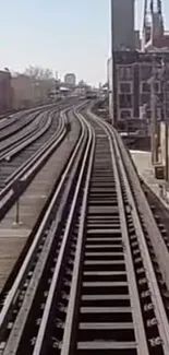 Urban railway track stretching into city horizon. Perfect mobile wallpaper.