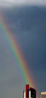 A vibrant rainbow arches over a modern city skyline.