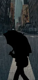 Silhouette with umbrella walking in rainy city street.