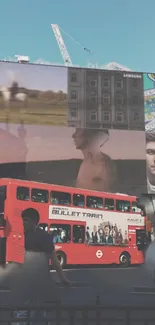 Red London bus with city billboards in background.