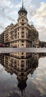 Urban landscape with building reflection on water under a cloudy sky.