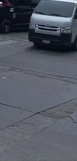 Urban street intersection with vehicles on the road.