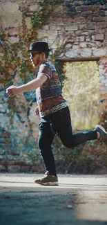 Man running in front of a brick wall with graffiti in an urban setting.