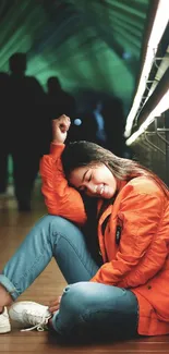 Woman in orange jacket sitting in an urban environment, exuding tranquility.