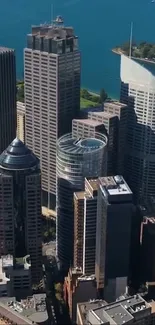 Aerial view of a modern city skyline with tall skyscrapers and a clear blue sky.