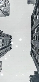 Vertical view of tall gray buildings against a clear sky.