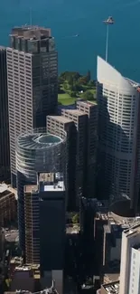 Mobile wallpaper of cityscape with skyscrapers under blue sky.