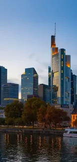 A city skyline at dusk with skyscrapers reflecting in the river.