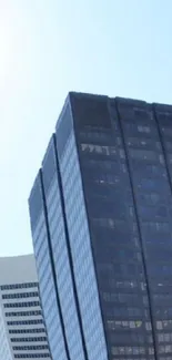 Skyscraper against a clear blue sky, showcasing modern urban architecture.