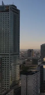 Mobile wallpaper of city skyline with skyscrapers under a blue sky.