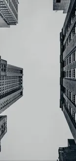 Vertical shot of urban skyscrapers against a gray sky.