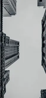 Monochrome skyline of tall urban skyscrapers against a gray sky.