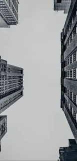 Monochrome urban skyline with towering buildings against a clear sky.