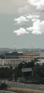 Cityscape under cloudy sky with sunset glow.