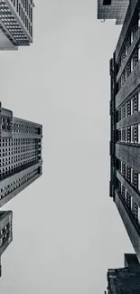 Upward view of towering skyscrapers in a monochrome city skyline.