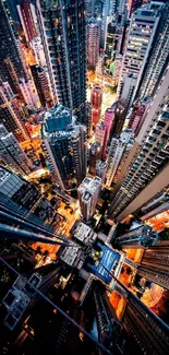 Aerial view of illuminated skyscrapers in a bustling city at night.