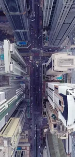 Vertical aerial view of city skyscrapers and busy streets.