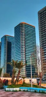 Skyscrapers glowing at sunset in urban park.